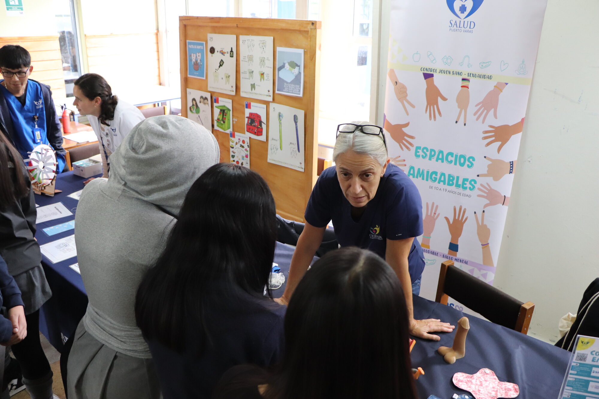 Estudiantes junto a un panel informativo durante la Feria de la Salud